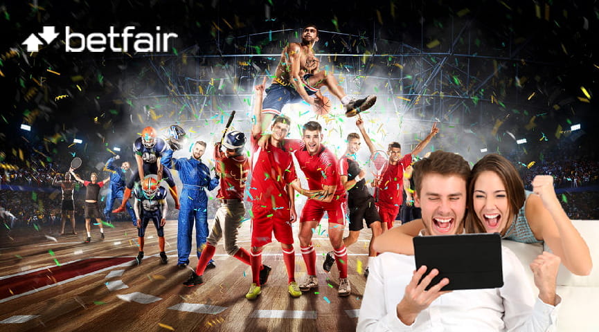Un ragazzo e una ragazza davanti a un tablet esultano per aver vinto a una scommessa. Sullo sfondo il logo di Betfair e alcuni atleti di varie discipline sportive in azione