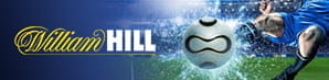 Il logo di William Hill accanto a un calciatore che calcia la sfera durante una partita